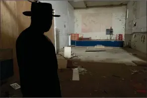  ?? (AP Photo/Sarah Blake Morgan) ?? The Rev. David Kennedy looks at a faded mural of Nazi and Confederat­e flags painted inside what was once “The Redneck Shop.” His fight for civil rights is on display in the new film Burden in Laurens, S.C.