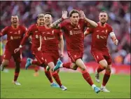  ?? Kirsty Wiggleswor­th / Associated Press ?? Liverpool players celebrate after Kostas Tsimikas scored the winning penalty in a shootout against Chelsea in the FA Cup final Saturday in London.