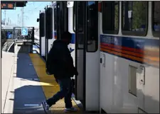  ?? HELEN H. RICHARDSON — THE DENVER POST ?? A passenger boards a northbound light rail train at Lincoln Station, an RTD light rail station in Lone Tree, on March 18.
