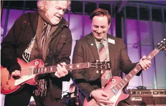  ?? LEAH HENNEL/ CALGARY HERALD ?? Andrew Mosker, president and CEO of the National Music Centre, right, jams with Randy Bachman playing the guitar on which Bachman wrote the iconic song, American Woman.