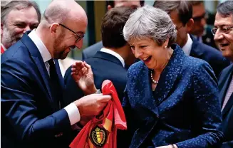  ??  ?? One-nil: Charles Michel presents Theresa May with a Belgium shirt yesterday