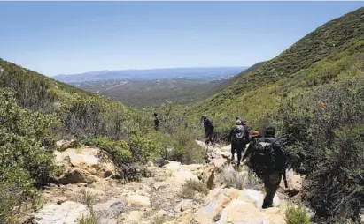  ?? ANA RAMIREZ U-T PHOTOS ?? Border Kindness volunteers hope that the supplies they dropped along the trail will help save lives of migrants traveling the arduous path from Mexico into the U.S. Weather conditions can change rapidly in the mountains and travelers are often unprepared.