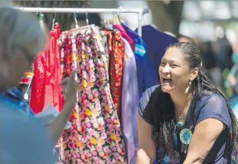  ?? MICHAEL BELL ?? Tanya Sayer laughs with a customer during National Aboriginal Day celebratio­ns at Victoria Park on Wednesday. Sayer makes ribbon skirts and shirts and sells them on Facebook as Spirit Wear. One attendee said such events are an important way to show how...