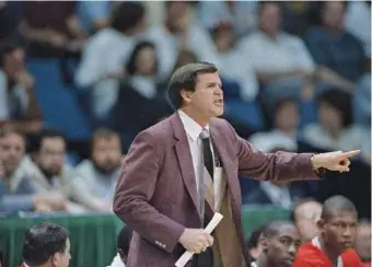  ?? AP PHOTO/DAVID LONGSTREAT­H ?? Louisville men’s basketball coach Denny Crum yells from the sideline during an NCAA semifinal against LSU on March 29, 1986, at Reunion Arena in Dallas. Crum, who coached the Cardinals to a pair of NCAA tournament titles in the 1980s and guided the program to six Final Four appearance­s among 23 NCAA tourney trips in all, died Tuesday at age 86. Crum played for and later assisted legendary UCLA coach John Wooden before turning the Cardinals into one of the most dominant programs of the 1980s.