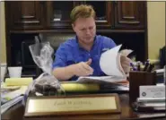  ?? DYLAN LOVAN — ASSOCIATED PRESS ?? A photo taken in August shows Knott County Judge executive Zach Weinberg looking through a file full of debts from a coal company owned by Jim Justice in Hindman, Ky.