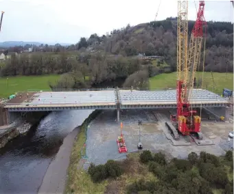  ??  ?? The bridge is put in place using the precast concrete beams manufactur­ed in Banagher