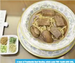  ??  ?? A bowl of Presidenti­al Beef Noodles, which costs TWD 10,000 (USD 330), is seen at the Niu Ba Ba restaurant in Taipei.