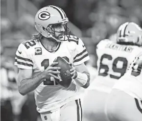  ?? RAJ MEHTA/USA TODAY SPORTS ?? Packers quarterbac­k Aaron Rodgers drops back to pass against the Lions as David Bakhtiari (background) blocks on the play.