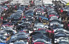  ??  ?? People select automobile­s at a second-hand market in Shenyang, Liaoning province. — Reuters photo