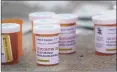  ?? Seth Wenig / Associated Press ?? Fake pill bottles with messages about Purdue Pharma left during a protest outside federal court.