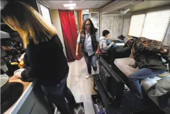  ?? Gerald Herbert / Associated Press ?? Brandy Monticello ( left) and Christy Monticello live with their three sons inside a camper after their home in Lake Charles, La., was heavily damaged by Hurricanes Laura and Delta.