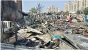  ?? PIC/PTI ?? Residents searching for their valuables among the remains of their gutted shanties after the fire in Gurugram on Monday