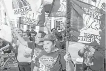  ?? Gary Fountain ?? Members of the Texas chapter of the Service Employees Internatio­nal Union commemorat­e “Justice for Janitors Day” during a rally in June downtown.