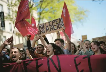  ?? CHRISTOPHE ENA/AP ?? A demonstrat­or holds a placard that reads: “Neither Macron nor Le Pen,” during a protest April 16 in Paris.