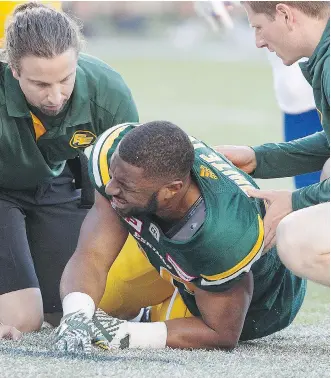  ?? JASON FRANSON/THE CANADIAN PRESS ?? Edmonton Eskimos running back John White tore his ACL Friday against the Montreal Alouettes. This is the second season-ending injury White has sustained in three seasons.