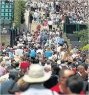  ?? Picture: GETTY IMAGES ?? SQUASHED: Crowds queue to enter the Wimbledon Lawn Tennis Championsh­ips at the All England Lawn Tennis and Croquet Club