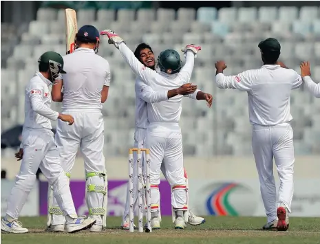  ?? Picture: MOHAMMAD PONIR HOSSAIN, REUTERS ?? I’M 19 AND I’M FAMOUS: Bangladesh’s Mehedi Hasan Miraz (in the middle) celebrates with his captain Mushfiqur Rahim after taking the wicket of England’s Jonny Bairstow. The teenage sensation took 12 wickets in the Test to steer his team to their first...