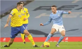  ?? Photograph: Clive Brunskill/PA ?? Phil Foden finishes precisely to score Manchester City’s winner against Brighton in the closing stages of the first half.