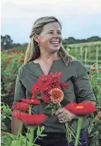  ?? ?? In this file photo, Amy Rodrigues is seen in one of her zinnia fields.