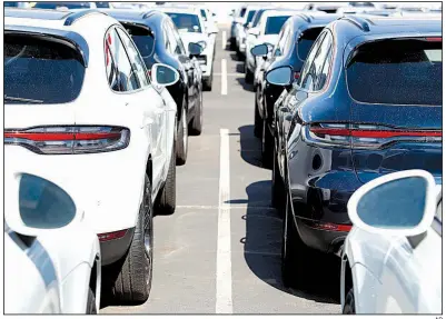  ?? AP ?? Unsold 2019 Porsche Cayenne sports utility vehicles sit recently at a dealership in Littleton, Colo. U.S. consumer spending on durable goods such as autos rose 0.4% in June, the Commerce Department said Tuesday.