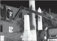  ?? Associated Press ?? Workers dismantle the Liberty Place monument Monday, which commemorat­es whites who tried to topple a biracial post-Civil War government.