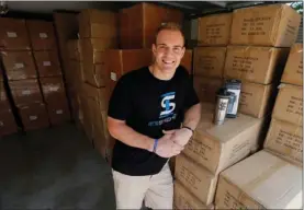  ?? AP PHOTO BY TONY GUTIERREZ ?? In this Aug. 31 photo, former NFL fullback Chris Gronkowski poses with boxes of his product, Ice Shaker, stacked in his garage, in Colleyvill­e, Texas. For business advice, Gronkowski turned to his father, who’d had his own company for 26 years. He...