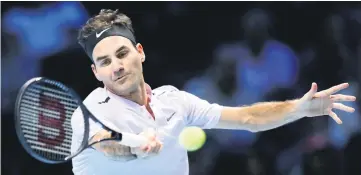  ?? — AFP photo ?? Roger Federer returns to Jack Sock during their men’s singles tennis match on Day One of the ATP World Tour Finals tennis tournament at the O2 Arena in London.