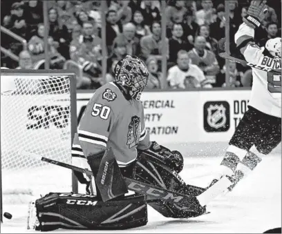  ?? ERIN HOOLEY/CHICAGO TRIBUNE ?? Corey Crawford gives up a goal against the Devils. He was pulled after allowing the goal, the fourth of the game, and hasn’t played since.