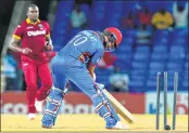  ??  ?? Dawlat Zadran (R) of Afghanista­n is bowled by Jerome Taylor (L) of West Indies.