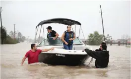  ??  ?? TEXAS: People are rescued from a flooded neighborho­od after it was inundated with rain water, remnants of Hurricane Harvey in Houston, Texas.