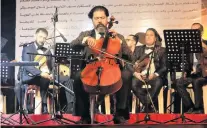  ?? PHOTO: REUTERS ?? We’re back . . . The Peace Through Arts Farabi Orchestra is led by conductor Karim Wasfi during a concert in Mosul on October 27.