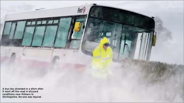  ??  ?? A bus lies stranded in a ditch after it went off the road in blizzard conditions near Killearn in Stirlingsh­ire. No-one was injured