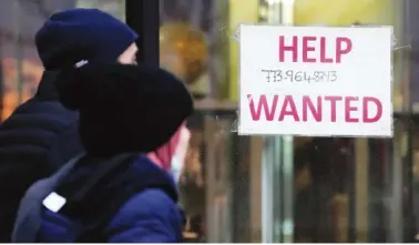  ?? AP PHOTO/NAM Y. HUH ?? A help wanted sign is displayed outside of a hair salon Jan. 5 in Chicago.