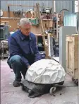  ??  ?? Tim Pomeroy prepares a sculpture for transporta­tion to his London exhibition.