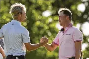  ?? MATT YORK / ASSOCIATED PRESS ?? Justin Thomas is greeted by Will Zalatoris after winning the PGA Championsh­ip in a playoff over Zalatoris on Sunday at Southern Hills Country Club in Tulsa, Okla.
