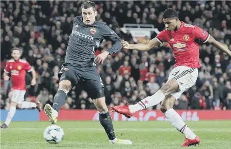  ??  ?? Marcus Rashford slams home Manchester United’s winner against CSKA Moscow at Old Trafford last night.