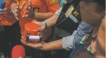  ?? FAUZY CHANIAGO/ASSOCIATED PRESS ?? A member of the National Transporta­tion Safety Committee holds the flight data recorder from the crashed Lion Air jet Thursday on board a research anchored in the waters of Tanjung Karawang, Indonesia.