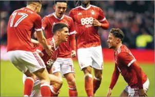  ?? OLI SCARFF/AFP ?? Nottingham Forest defender Eric Lichaj (centre) celebrates scoring his side’s first goal in their FA Cup third-round victory over Arsenal on Sunday.