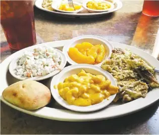  ?? STAFF PHOTO BY MARK PACE ?? Farmhouse’s chicken casserole special with sides of macaroni and cheese, peaches, coleslaw, roll and sweet tea.