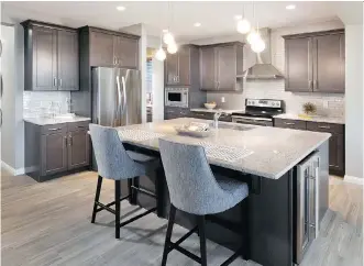  ?? PHOTOS: MORRISON HOMES ?? The roomy kitchen has a central island with extended eating bar.