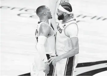  ?? TONY GUTIERREZ AP ?? Russell Westbrook, left, chest-bumping Anthony Davis on Wednesday, entered health protocols Thursday.