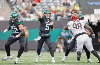  ?? Sarah Stier / Getty Images ?? The Jets’ Mike White, making his first career start, throws early in New York’s 34-31 win over Cincinnati on Sunday. White threw for 405 yards and three touchdowns.