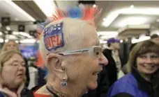  ?? DAVID J. PHILLIP/AP ?? Mary Steinkraus, from Germantown, Wis., wears her NFL mohawk as she visits radio row at the Super Bowl XLVI media centre on Friday.