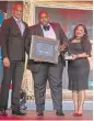  ??  ?? Phumlani Dyini, centre, with Irmsa President Berenice Francis and Brendan Maseti, Risk Manager of the Year 2017.