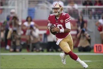  ?? PHOTOS BY TONY AVELAR — THE ASSOCIATED PRESS FILE ?? San Francisco 49ers quarterbac­k Jimmy Garoppolo (10) rolls out against the Kansas City Chiefs during the first half of a preseason game in Santa Clara on Saturday, Aug. 14.