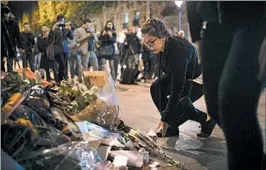  ?? KAMIL ZIHNIOGLU/AP ?? A woman mourns the shooting death of a French policeman on the Champs-Elysees.