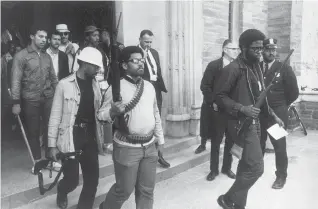  ?? Steve Starr/Associated Press ?? Heavily armed African American students leave Straight Hall at Cornell University in Ithaca, N.Y., on April 20, 1969, after barricadin­g themselves in the building led by Ed Whitfield, far right, demanding a degree-granting African American Studies program. The image won the 1970 Pulitzer Prize for spot news photograph­y.