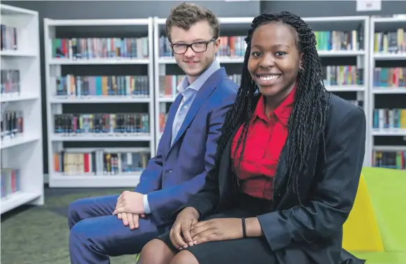  ?? Victor Besa / The National ?? The race is on between dozens of universiti­es to beat Brighton College Abu Dhabi students Edward Garemo and Dami Adekeye, both 17