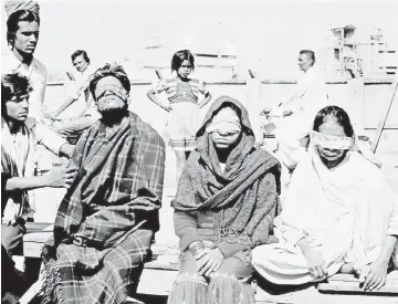  ?? — AFP photo ?? In this photograph taken on Dec 4, 1984, victims who lost their sight in the Bhopal poison gas tragedy sat outside the Union Carbide factory in Bhopal.