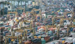  ??  ?? SINGAPORE: A general view of Tanjong Pagar container terminal is seen yesterday. Singapore exports in February surged with its strongest growth in five years, with increased demand from its top 10 markets. — AFP